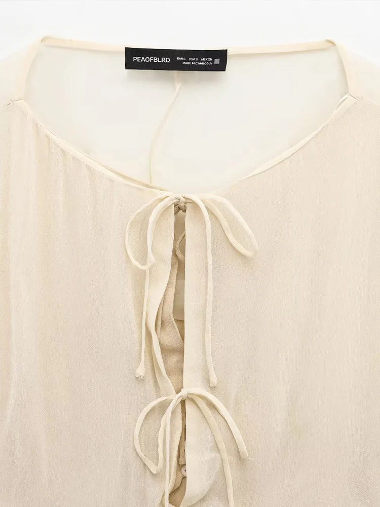 New spring women's clothing European and American style ruffled edge lace-up fake two-piece layered trumpet sleeve shirt.