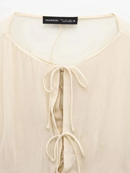 New spring women's clothing European and American style ruffled edge lace-up fake two-piece layered trumpet sleeve shirt.