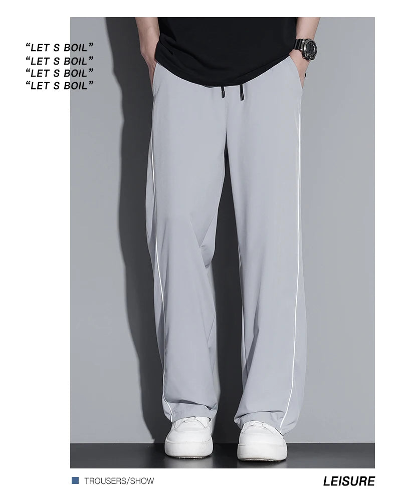 Summer ice silk thin section pants men's Hong Kong style loose splicing casual sports wide-legged pants elastic speed pants.