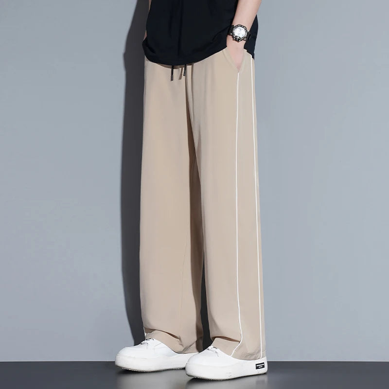Summer ice silk thin section pants men's Hong Kong style loose splicing casual sports wide-legged pants elastic speed pants.