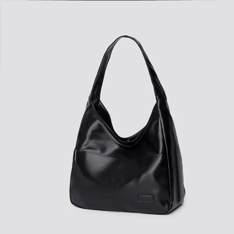 Large capacity tote bag, new black leather simple casual commuting women's bag, fashionable and versatile single shoulder bag.