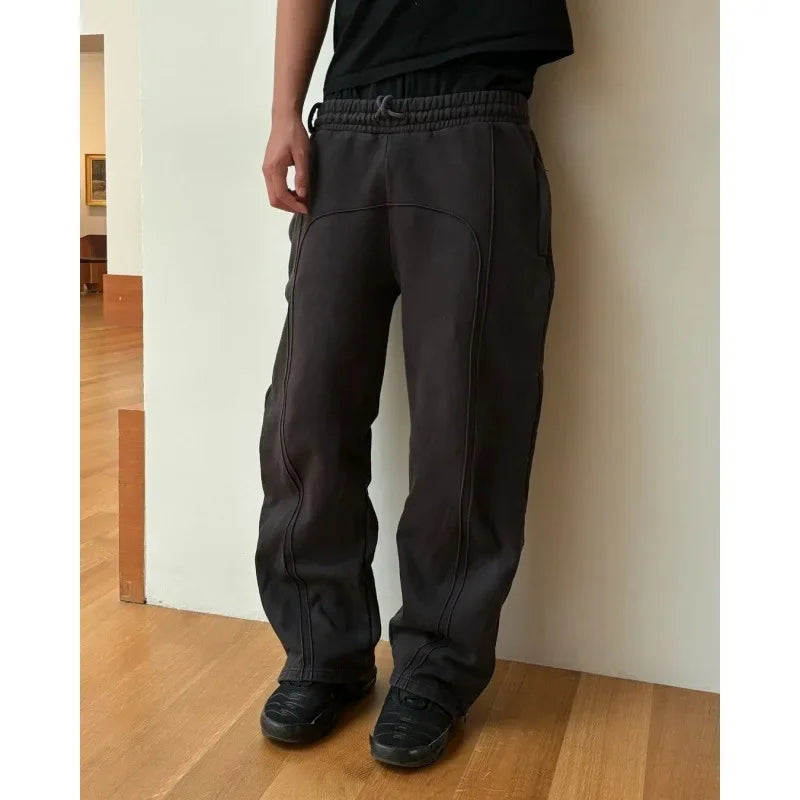 Casual Elastic Drawstring Zipper Pants High Street Hip Hop Streetwear Loose Fit Men's Trousers for Casual Scenarios.