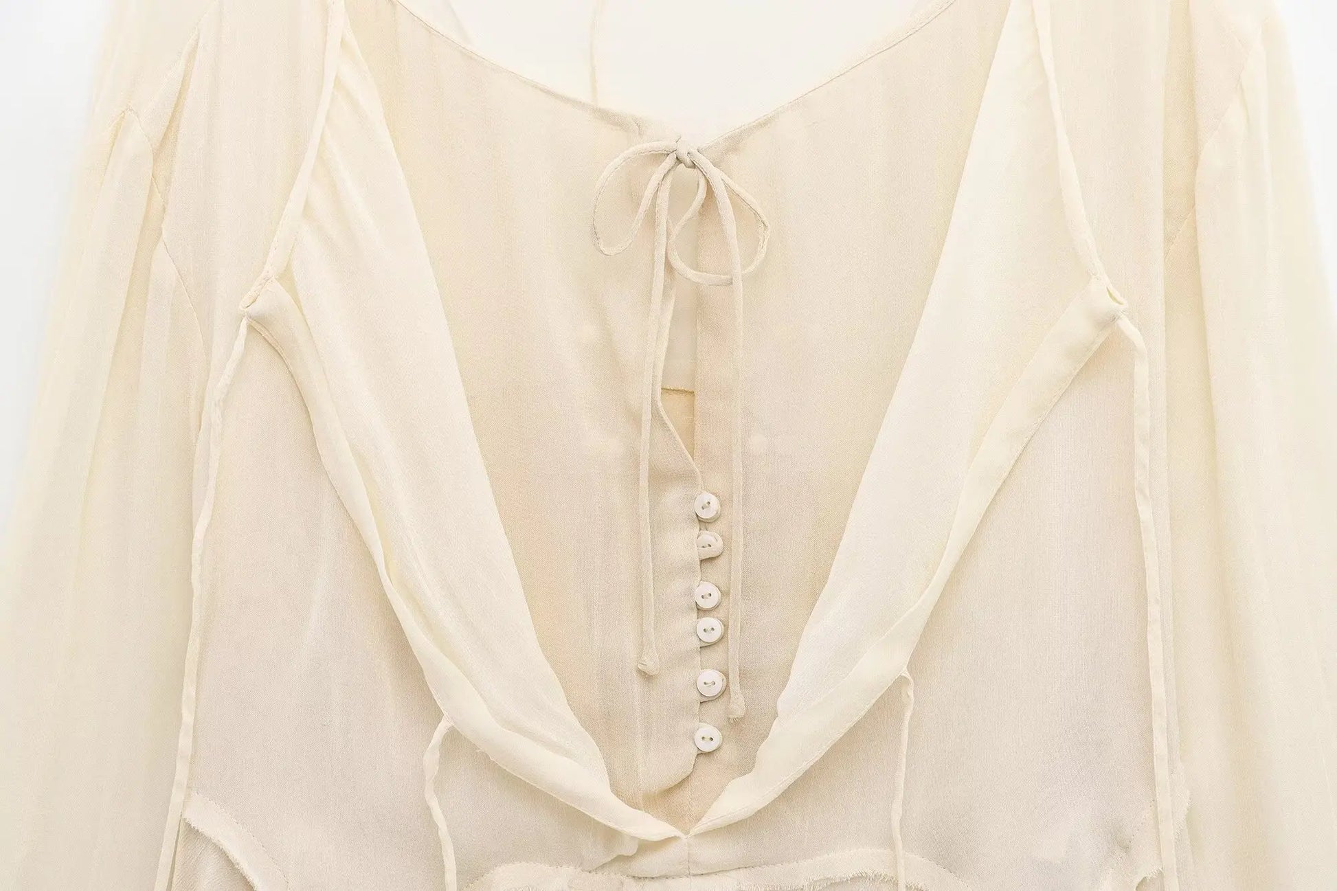 New spring women's clothing European and American style ruffled edge lace-up fake two-piece layered trumpet sleeve shirt.