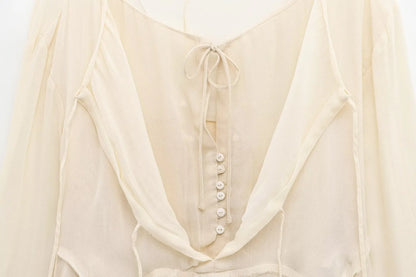 New spring women's clothing European and American style ruffled edge lace-up fake two-piece layered trumpet sleeve shirt.