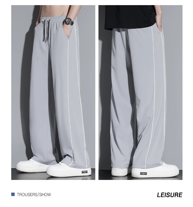 Summer ice silk thin section pants men's Hong Kong style loose splicing casual sports wide-legged pants elastic speed pants.