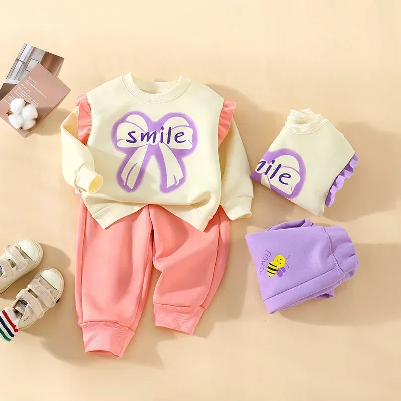 New 2025 Girls Fashion Cartoon Bowknot Letter Long Sleeve Pullover Sweatshirt + Pants Kids Spring Casual Sports Clothing Sets.