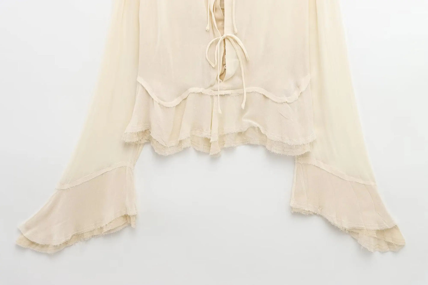 New spring women's clothing European and American style ruffled edge lace-up fake two-piece layered trumpet sleeve shirt.