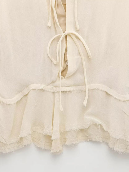 New spring women's clothing European and American style ruffled edge lace-up fake two-piece layered trumpet sleeve shirt.