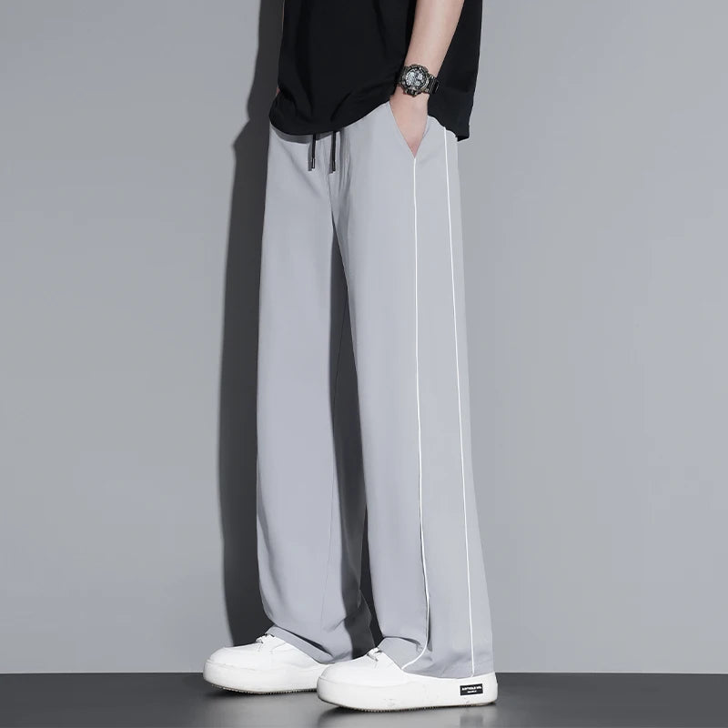 Summer ice silk thin section pants men's Hong Kong style loose splicing casual sports wide-legged pants elastic speed pants.
