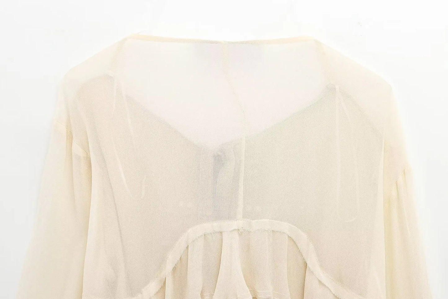 New spring women's clothing European and American style ruffled edge lace-up fake two-piece layered trumpet sleeve shirt.