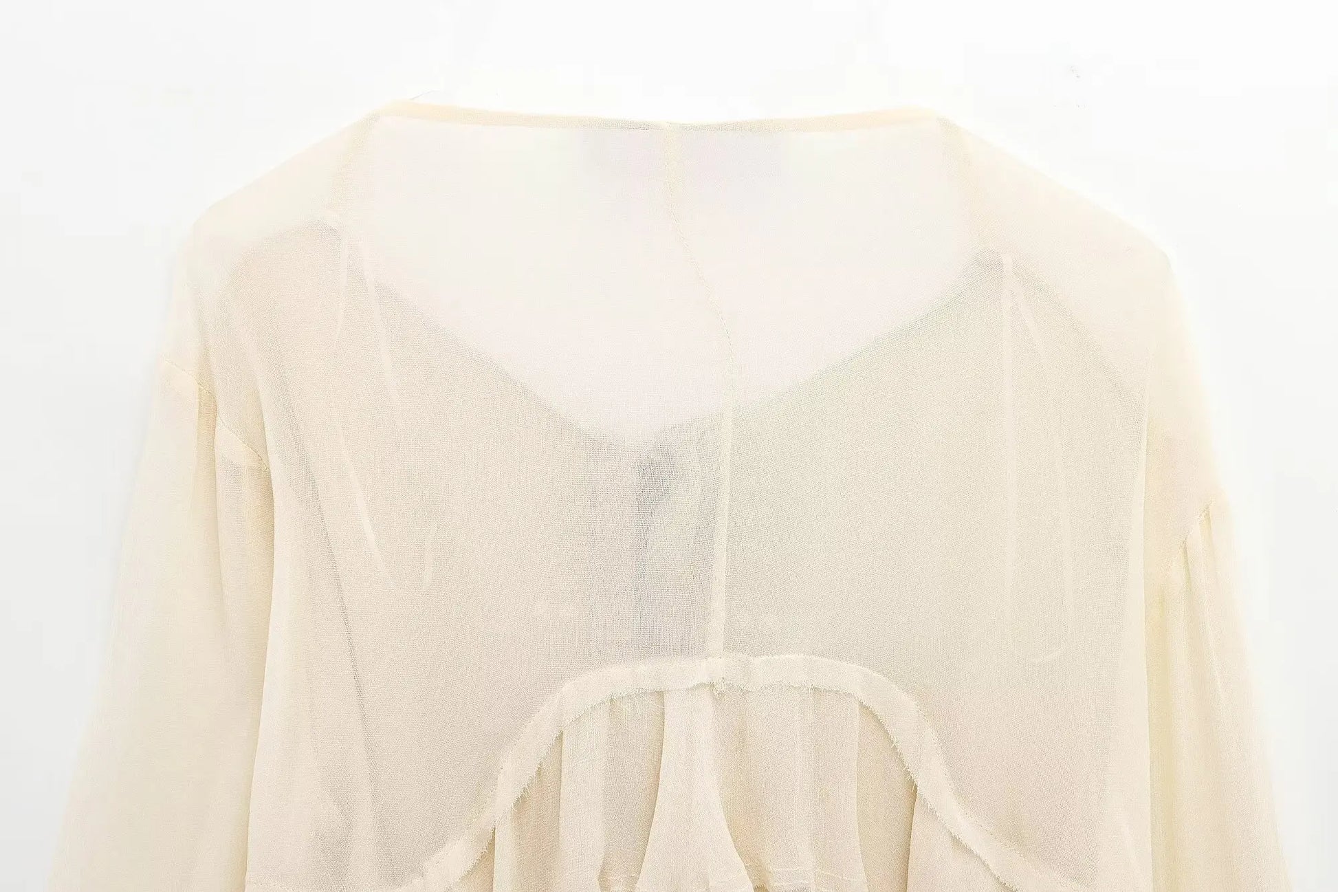 New spring women's clothing European and American style ruffled edge lace-up fake two-piece layered trumpet sleeve shirt.