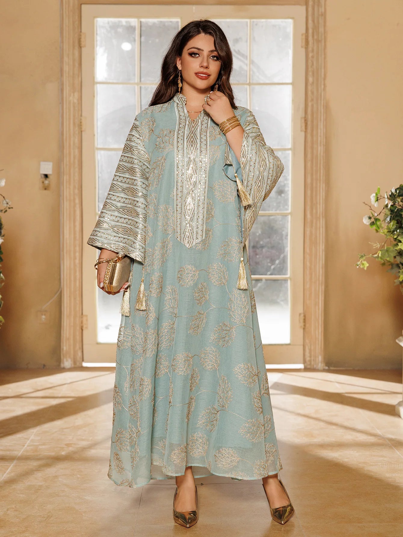 Muslim Women's Light Blue Islamic Embroidered Abaya with Gold Detailing Ideal for Formal Events in Middle East like UAE Saudi.