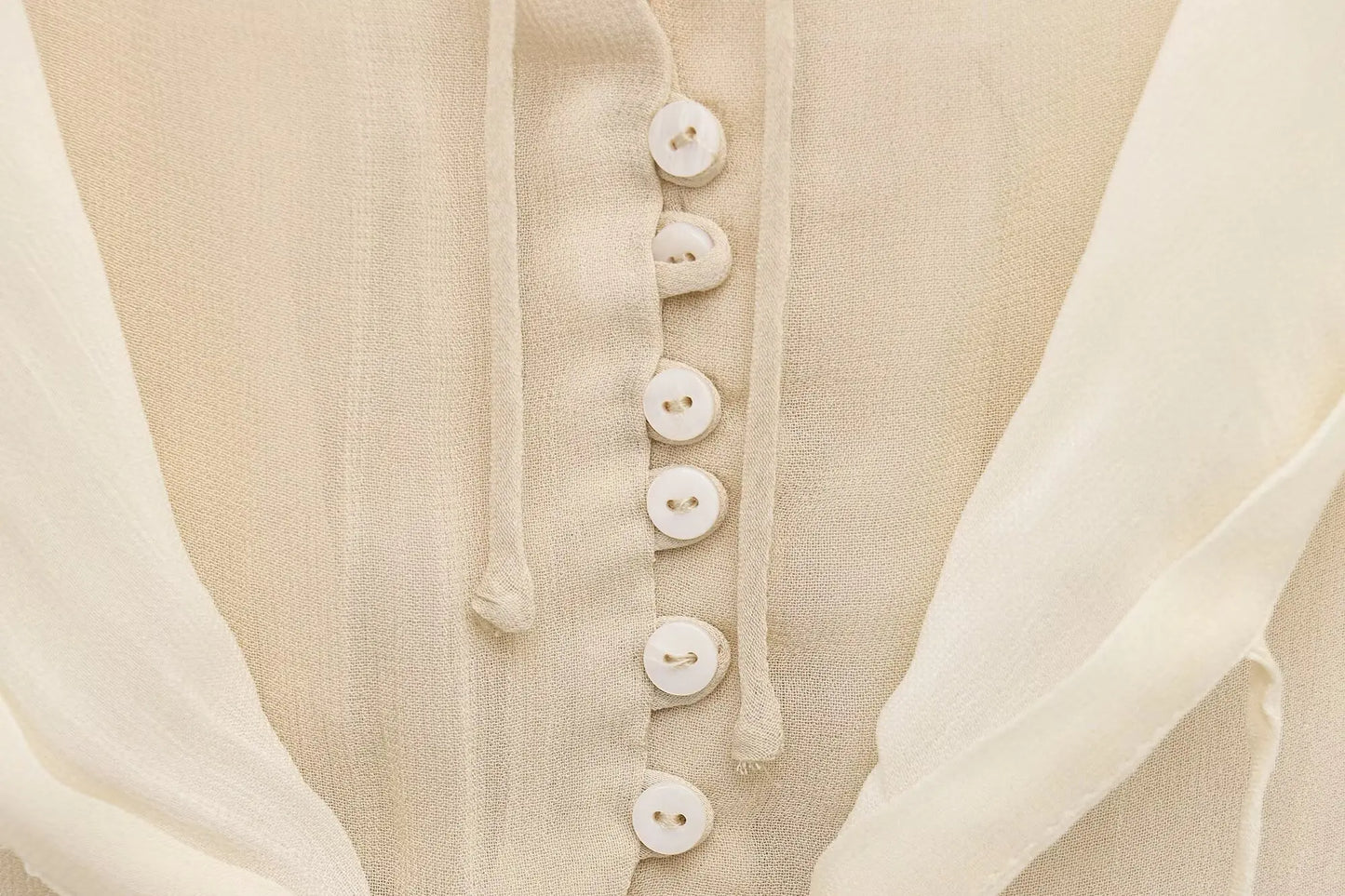 New spring women's clothing European and American style ruffled edge lace-up fake two-piece layered trumpet sleeve shirt.