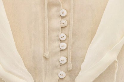 New spring women's clothing European and American style ruffled edge lace-up fake two-piece layered trumpet sleeve shirt.