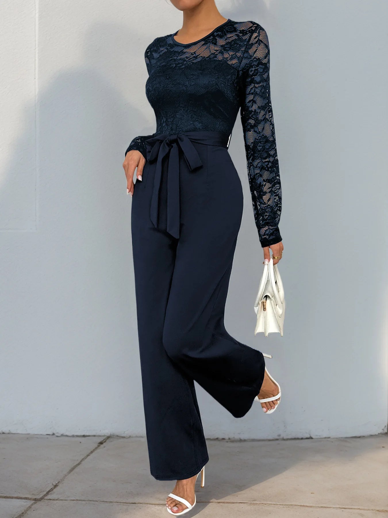 Woman Black Lace Sleeve Jumpsuit Round Neck Belted Waist Ideal for Evening Parties and Cocktail Events.