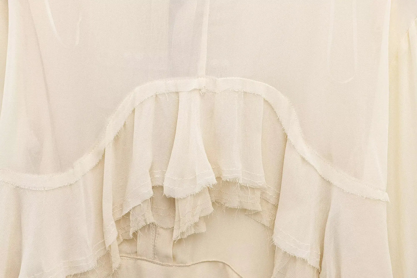 New spring women's clothing European and American style ruffled edge lace-up fake two-piece layered trumpet sleeve shirt.