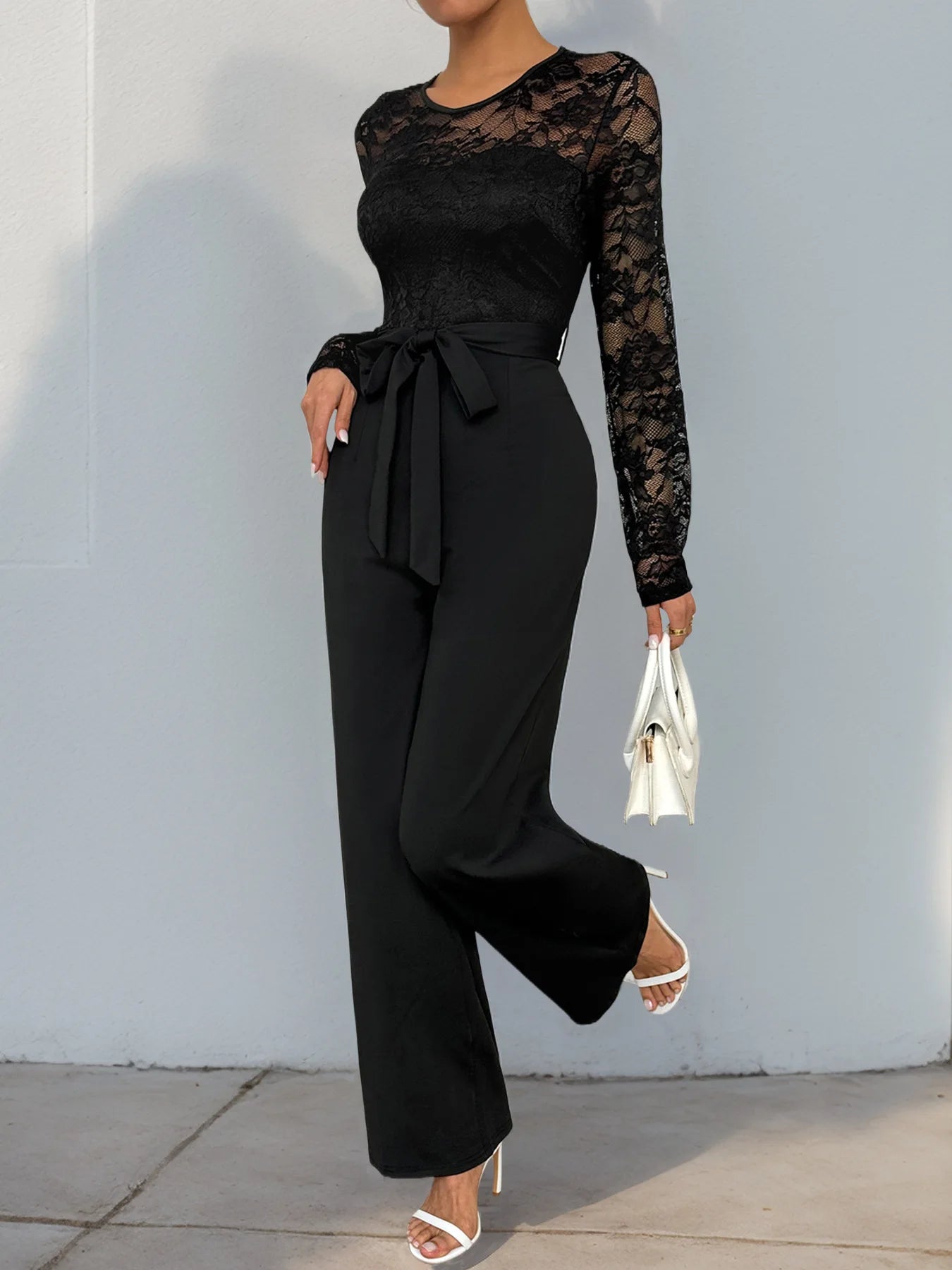 Woman Black Lace Sleeve Jumpsuit Round Neck Belted Waist Ideal for Evening Parties and Cocktail Events.