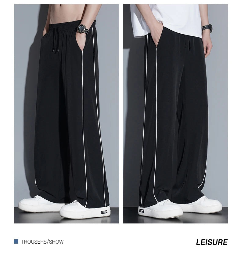 Summer ice silk thin section pants men's Hong Kong style loose splicing casual sports wide-legged pants elastic speed pants.