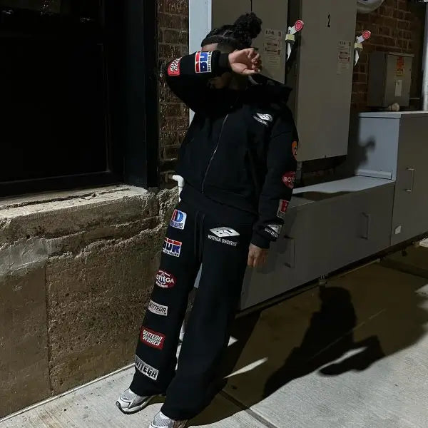 Black trendy patterned hip-hop sportswear set Y2K hooded zipper top with brand logo print and multiple badges streetwear fashion.