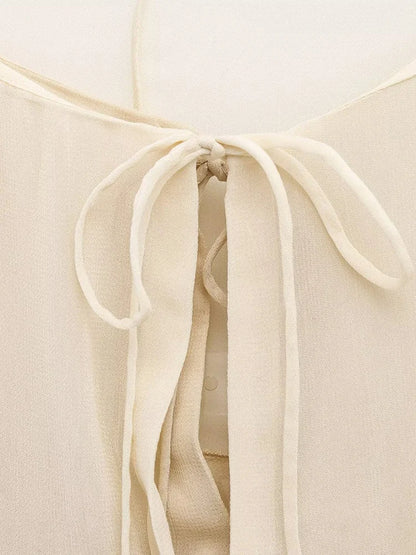 New spring women's clothing European and American style ruffled edge lace-up fake two-piece layered trumpet sleeve shirt.