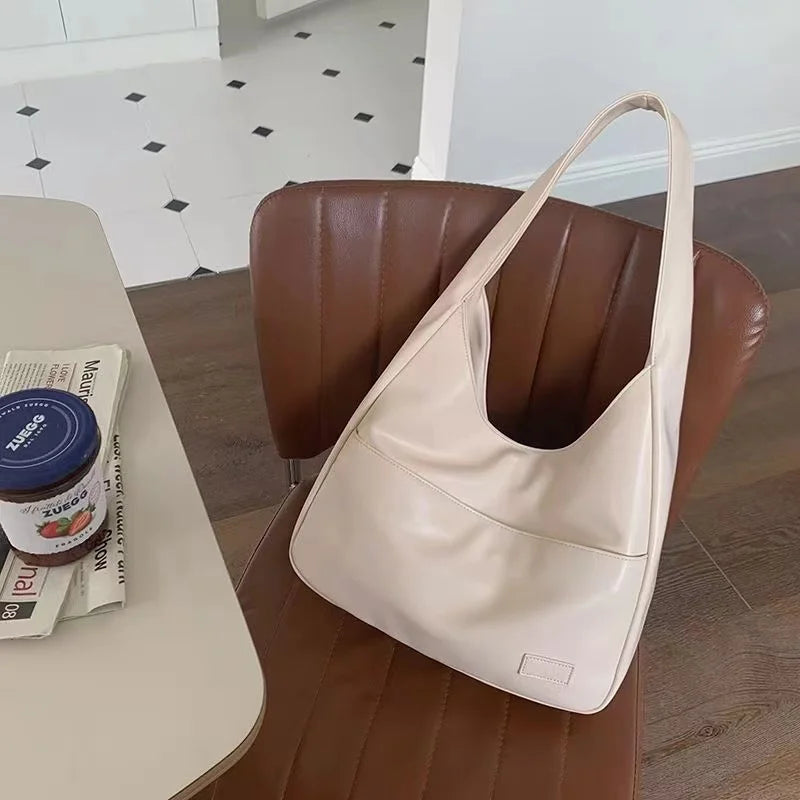 Large capacity tote bag, new black leather simple casual commuting women's bag, fashionable and versatile single shoulder bag.