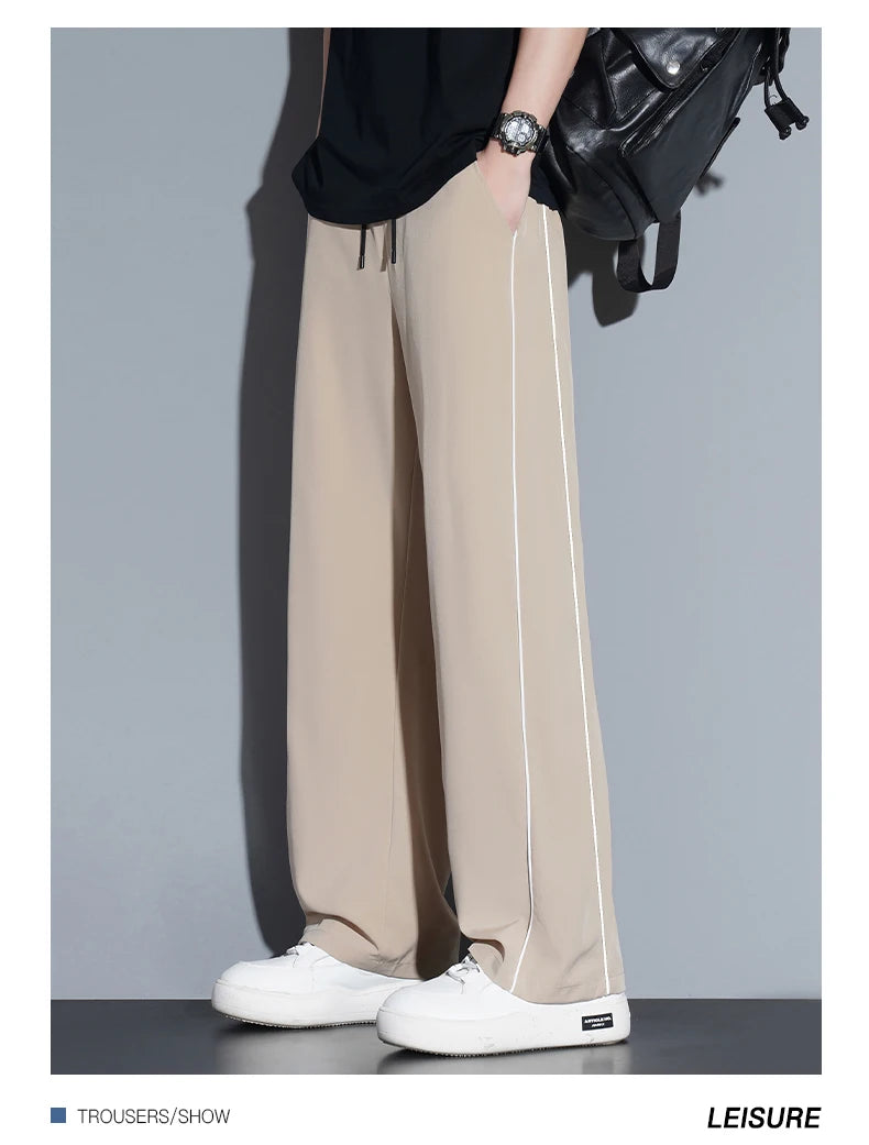 Summer ice silk thin section pants men's Hong Kong style loose splicing casual sports wide-legged pants elastic speed pants.