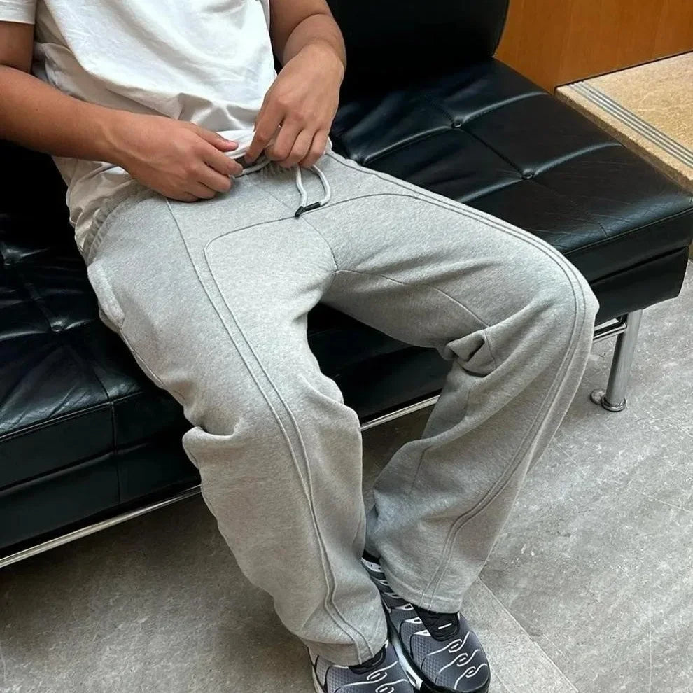 Casual Elastic Drawstring Zipper Pants High Street Hip Hop Streetwear Loose Fit Men's Trousers for Casual Scenarios.