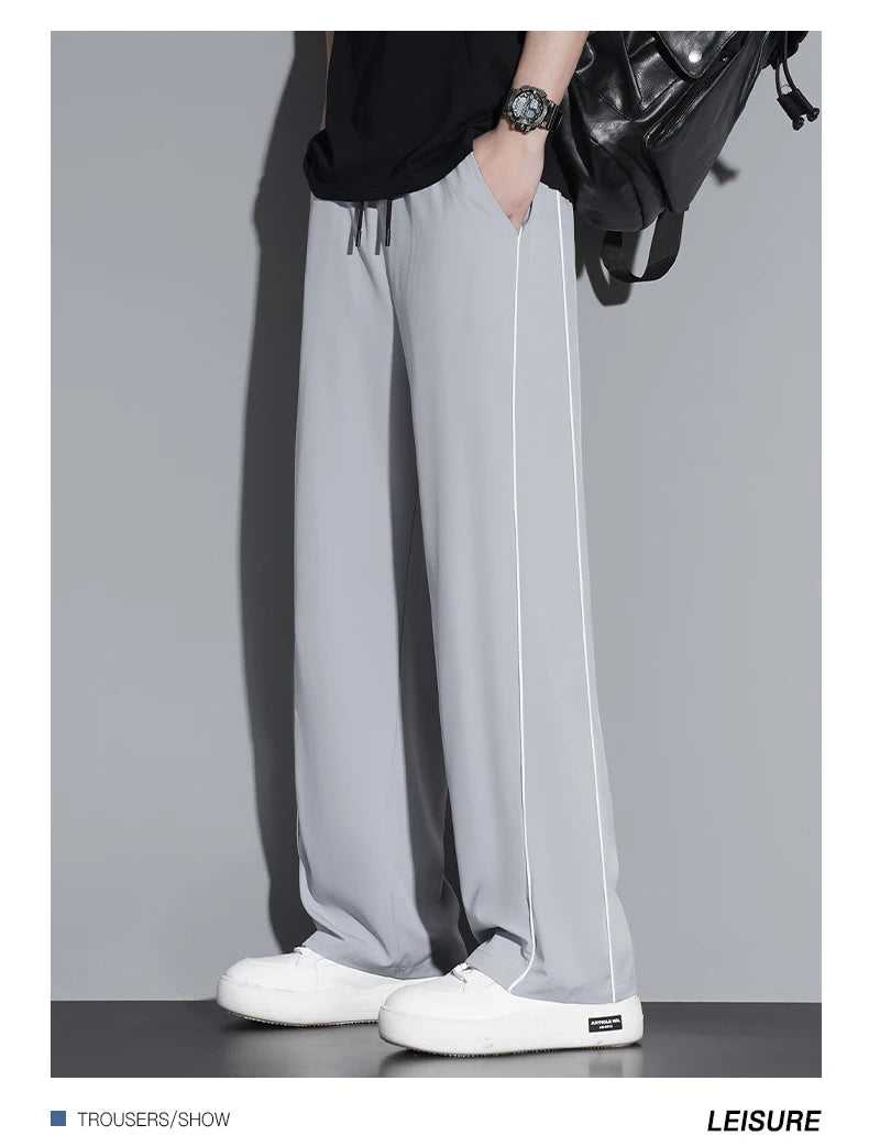 Summer ice silk thin section pants men's Hong Kong style loose splicing casual sports wide-legged pants elastic speed pants.