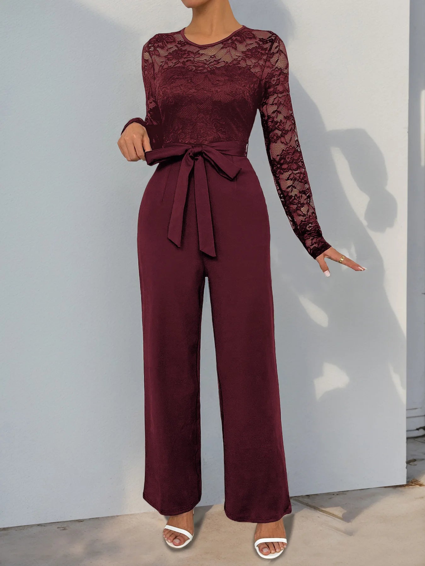 Woman Black Lace Sleeve Jumpsuit Round Neck Belted Waist Ideal for Evening Parties and Cocktail Events.